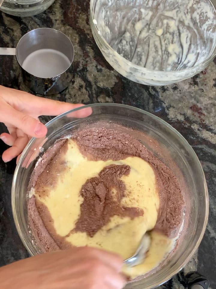 The wet and dry chocolate cake ingredients in a bowl.