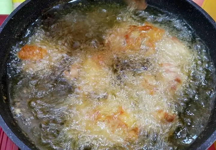 chicken frying in hot oil