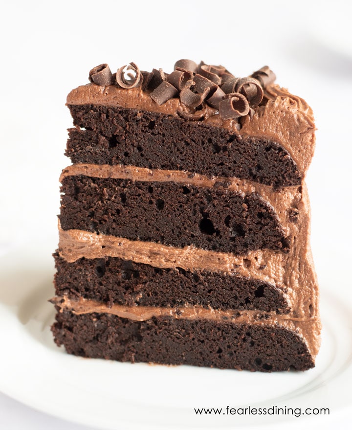 A piece of chocolate plate standing up tall on a plate.