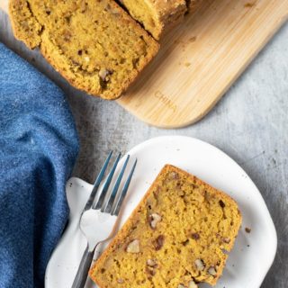 The top view of a slice of pumpkin bread on a plate.