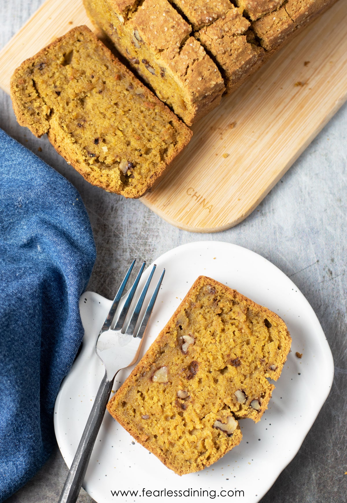 The top view of a slice of pumpkin bread on a plate.