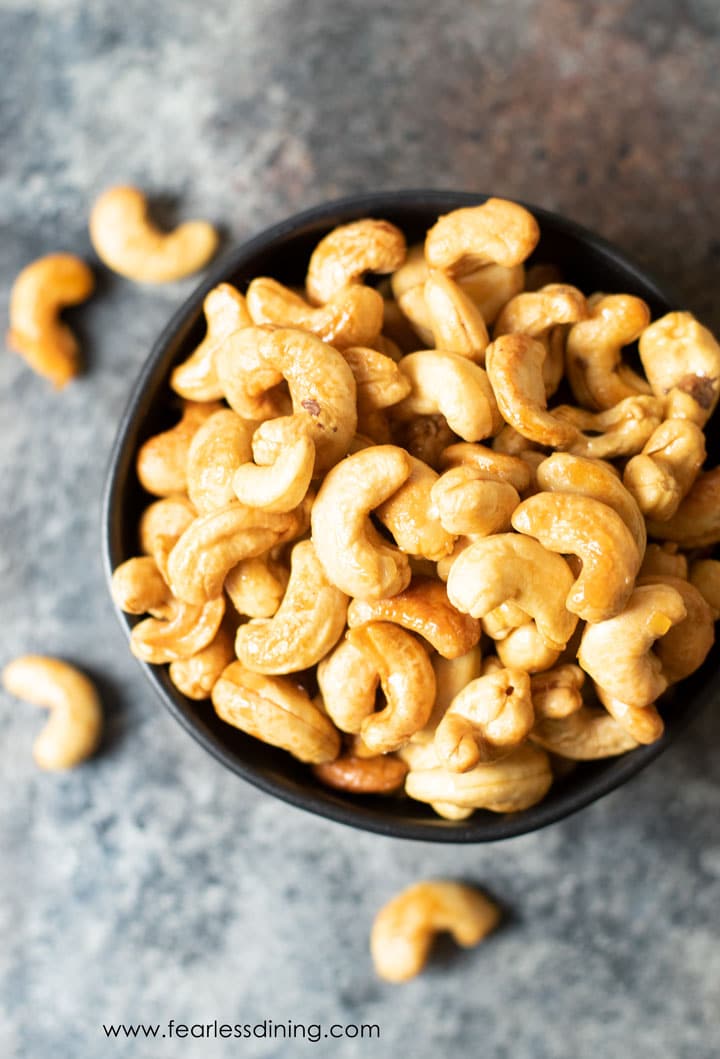 The top view of a bowl of honey roasted cashews.