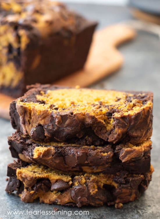 A stack of three slices of chocolate pumpkin cake.