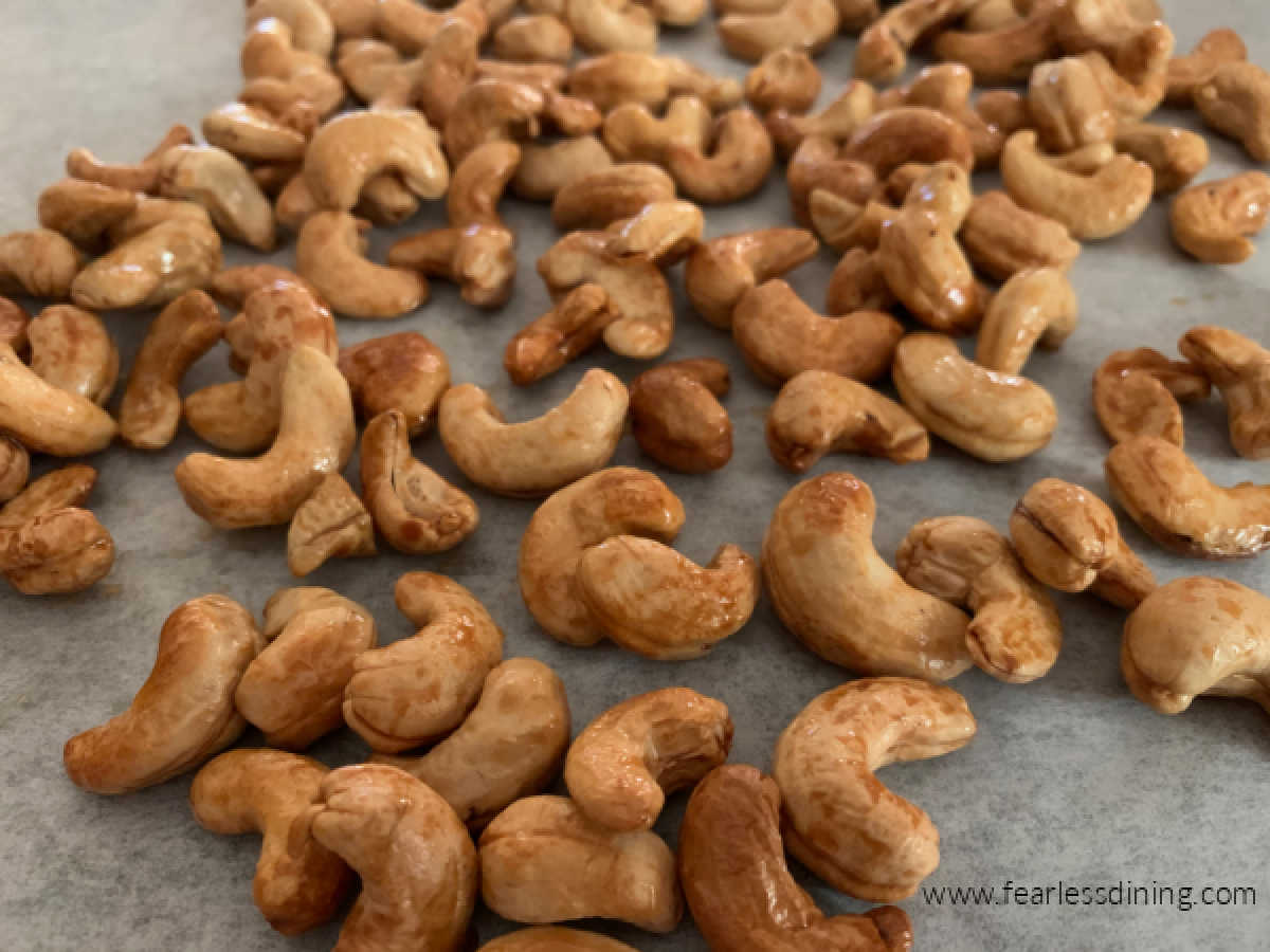 Roasted honey cashews on a baking tray.