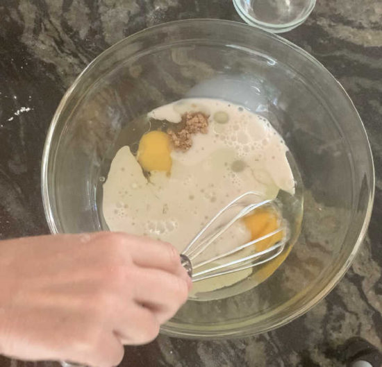 Whisking the wet ingredients in a bowl.