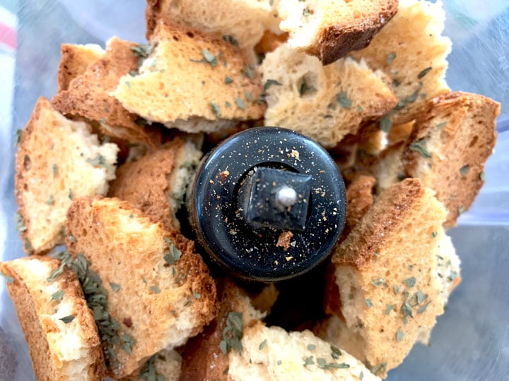 Dried bread chunks and Italian seasonings in a food processor.