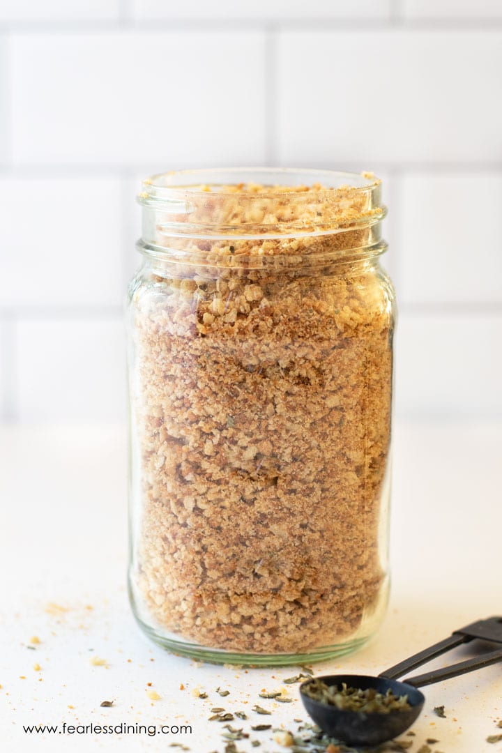 A quart-sized mason jar filled with gluten free breadcrumbs.