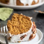 A slice of gluten free pumpkin bundt cake on a plate with a fork.