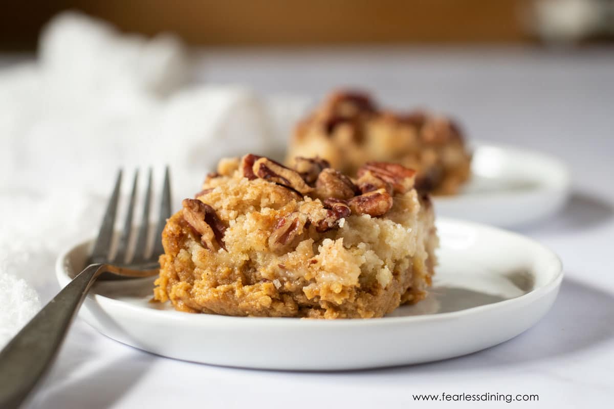 A slice of gluten free pumpkin dump cake on a plate.