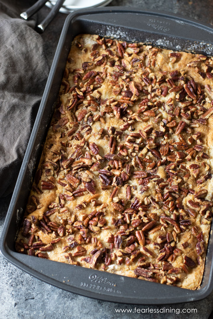 A baked pumpkin dump cake in a 9x13 silver baking pan.