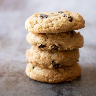 A stack of four gluten free rum raisin cookies.