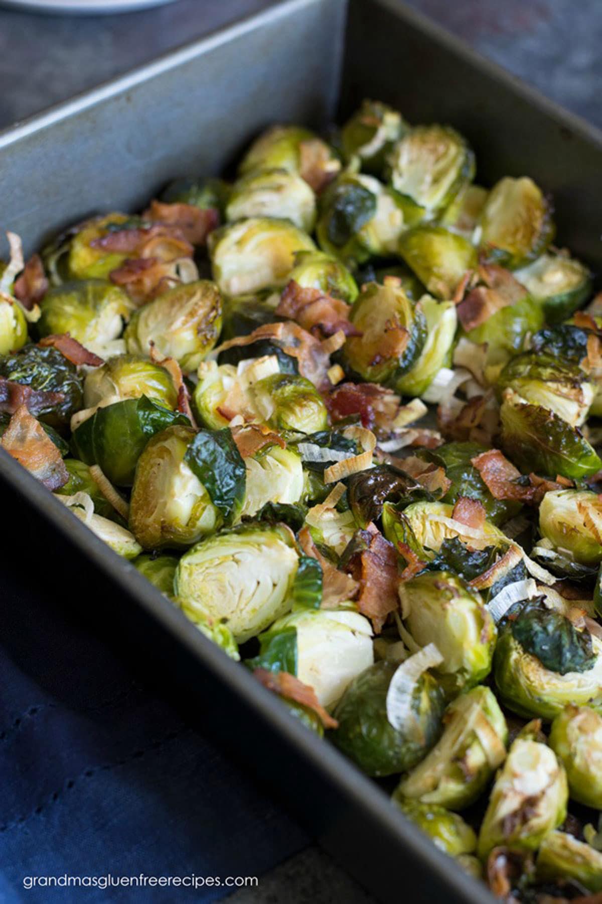 A roasting pan filled with roasted Brussels sprouts.
