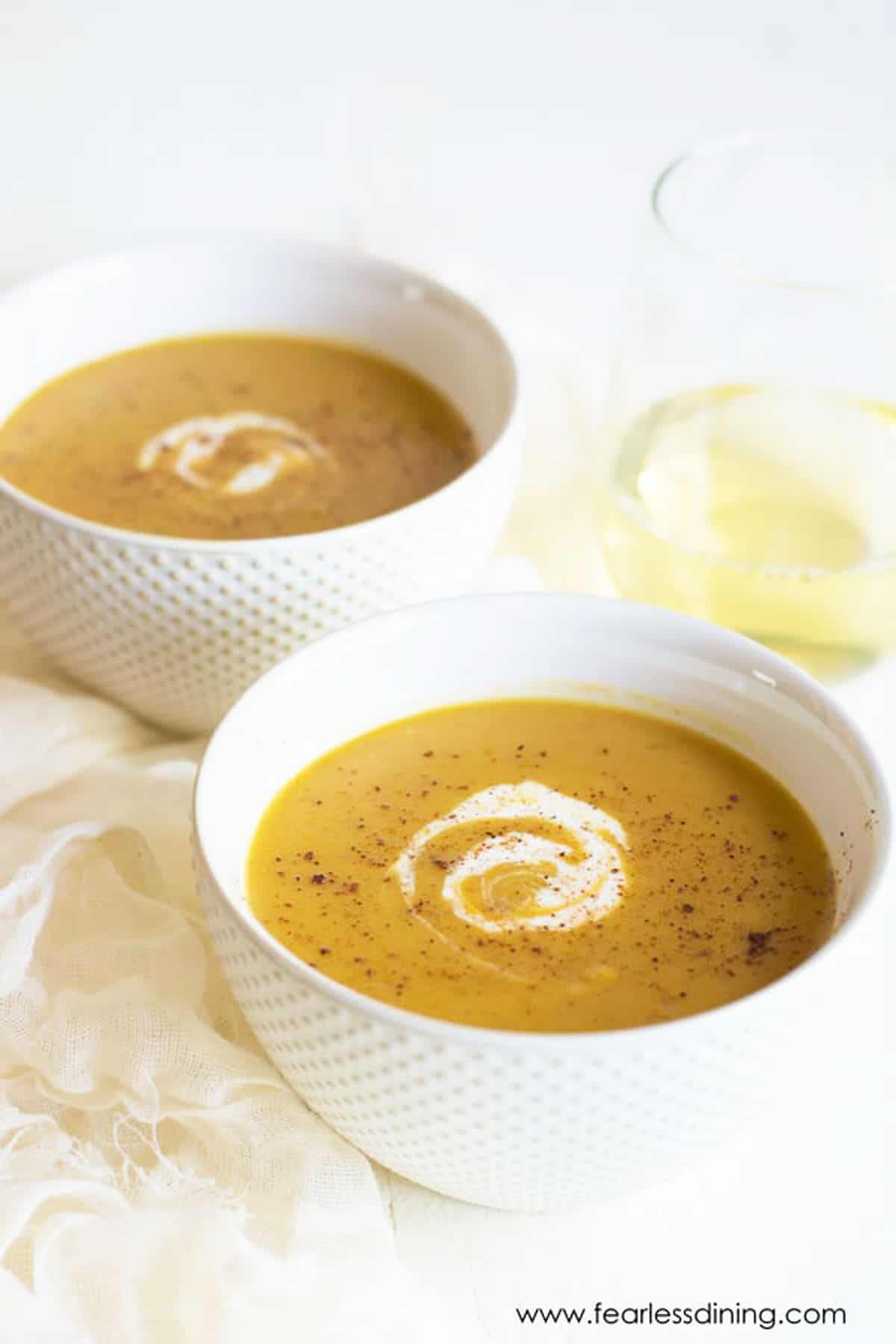 Two bowls of butternut squash soup.