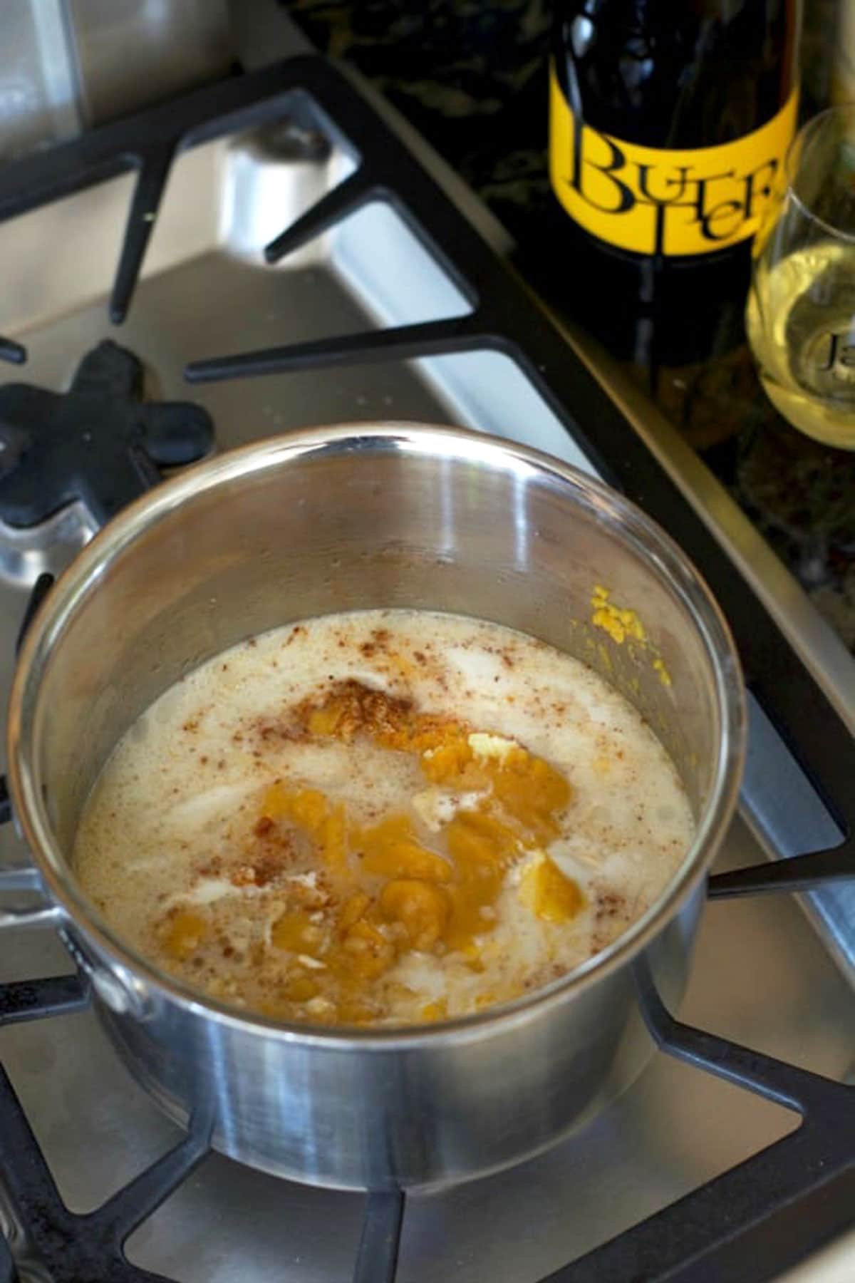 a pot of butternut squash soup cooking on the stove