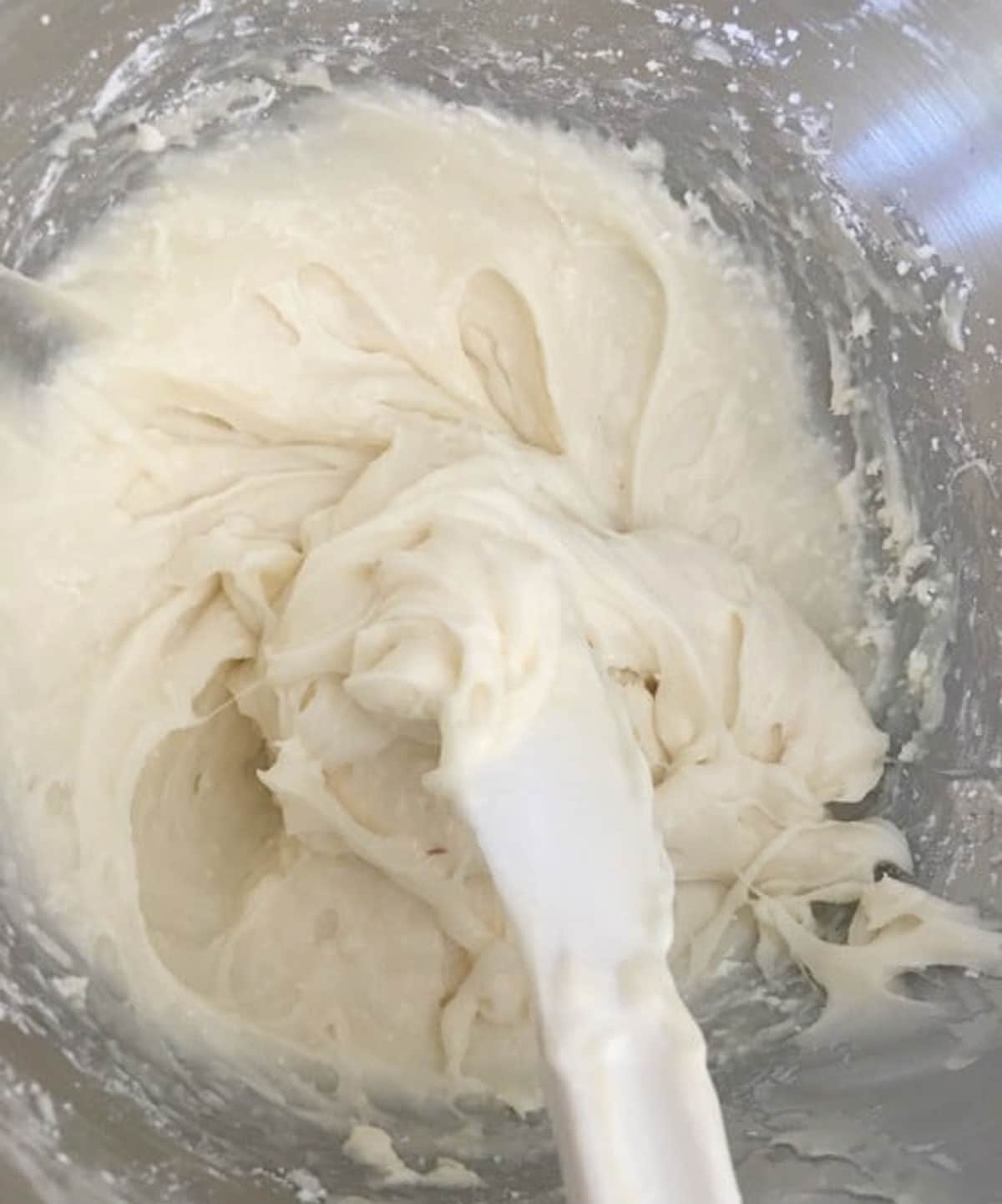 The whipped cream cheese frosting in a bowl.