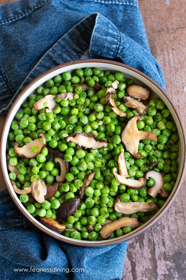 The top view of a large bowl of ginger peas.