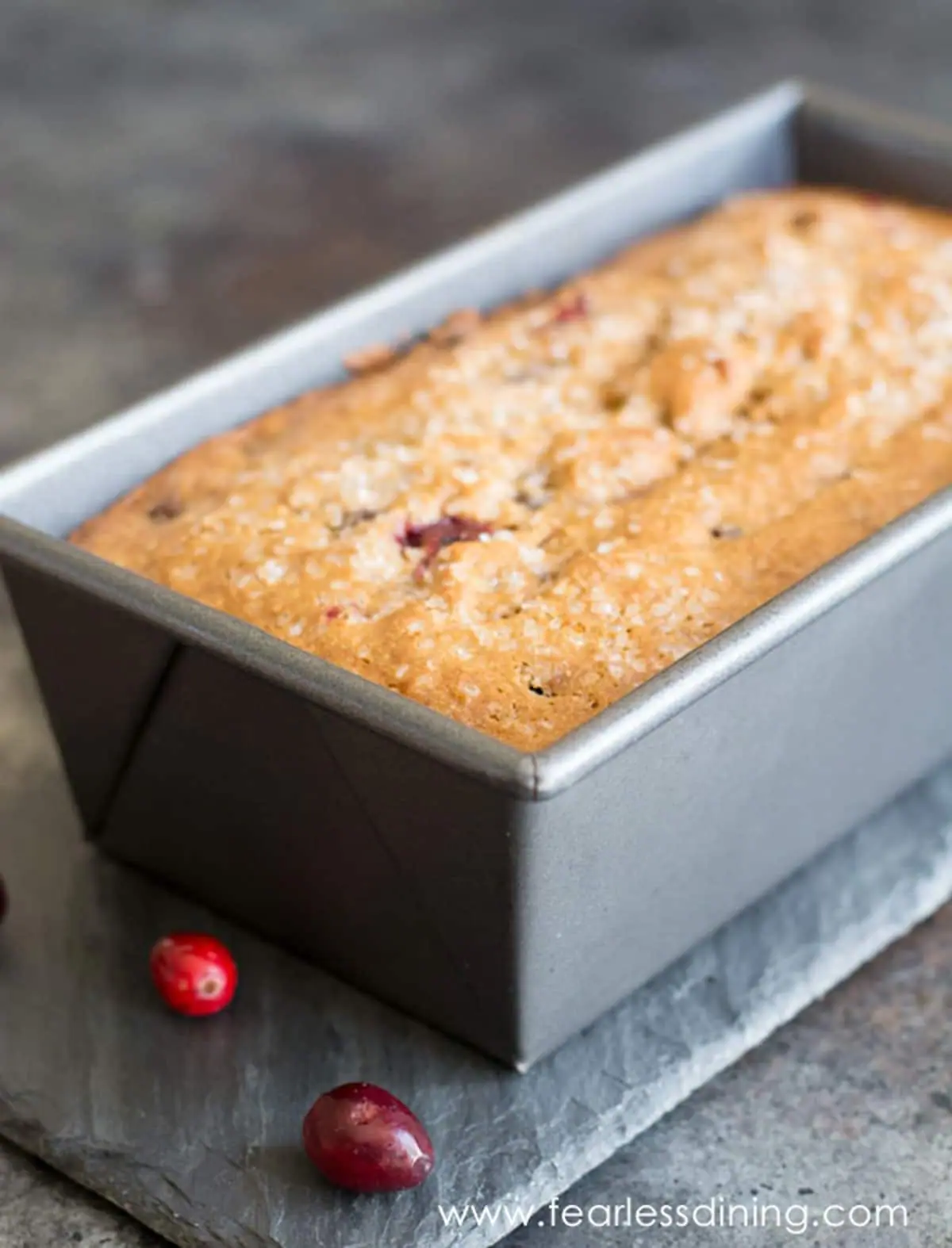a baked cranberry bread in a loaf tin