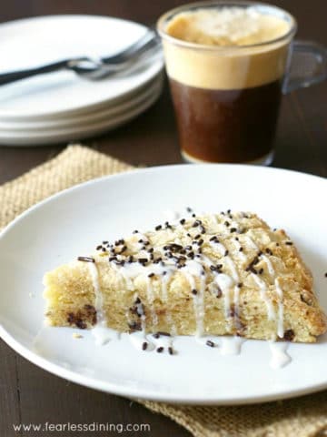 an eggnog scone on a plate next to a mug of coffee