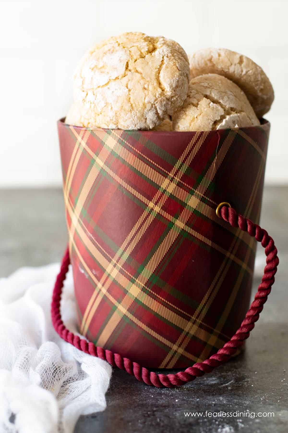 A maroon gift box filled with eggnog cookies.