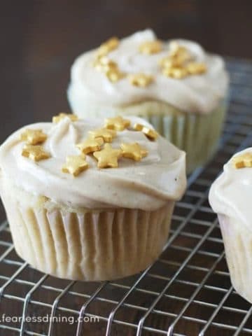 decorated eggnog cupcakes on a rack