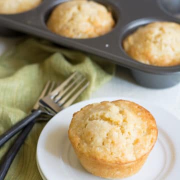 A French apple cake on a plate near the cake pan.