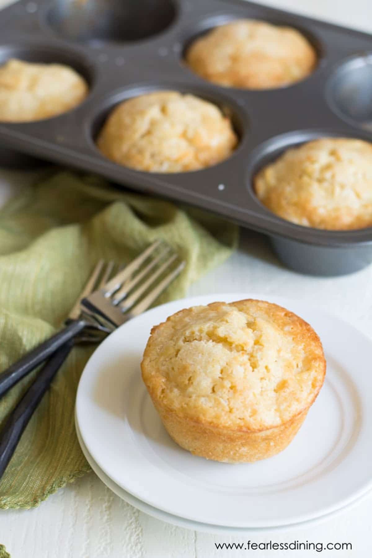 A French apple cake on a plate near the cake pan.