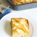 A slice of gluten free German apple cake on a small white plate.