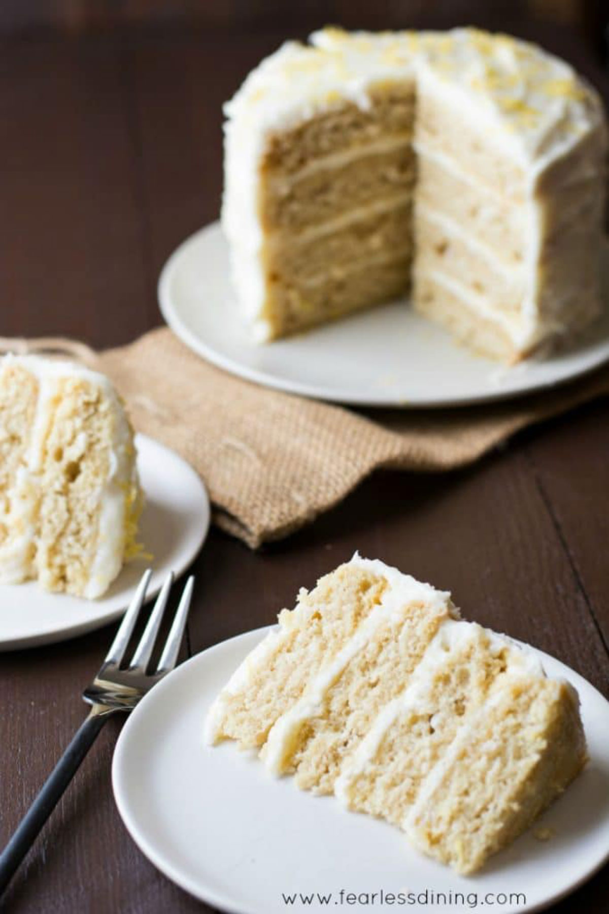 Two slices of lemon cake on plates.