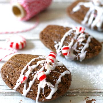 A row of chocolate madeleines with crushed candy cane on top.