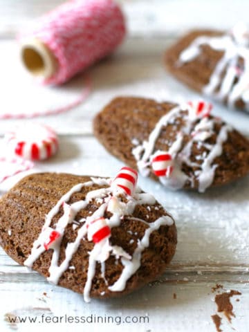 a row of chocolate madeleines with crushed candy cane on top