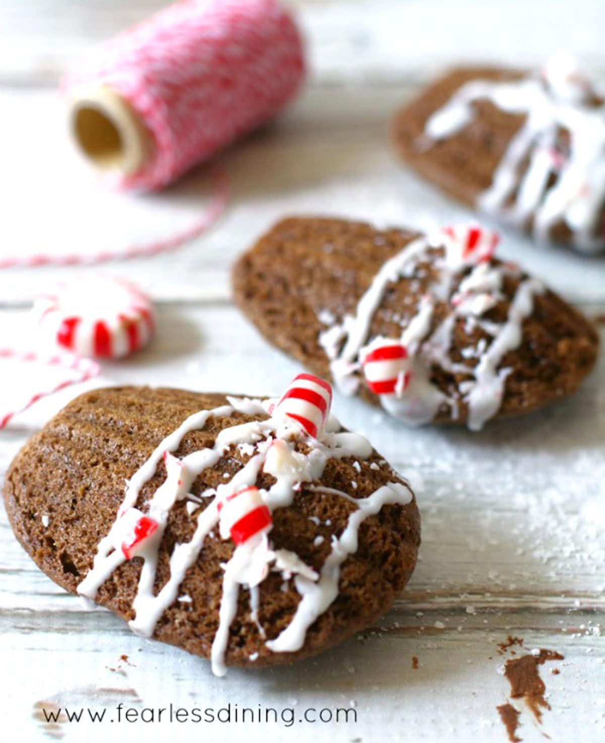 A row of chocolate madeleines with crushed candy cane on top.