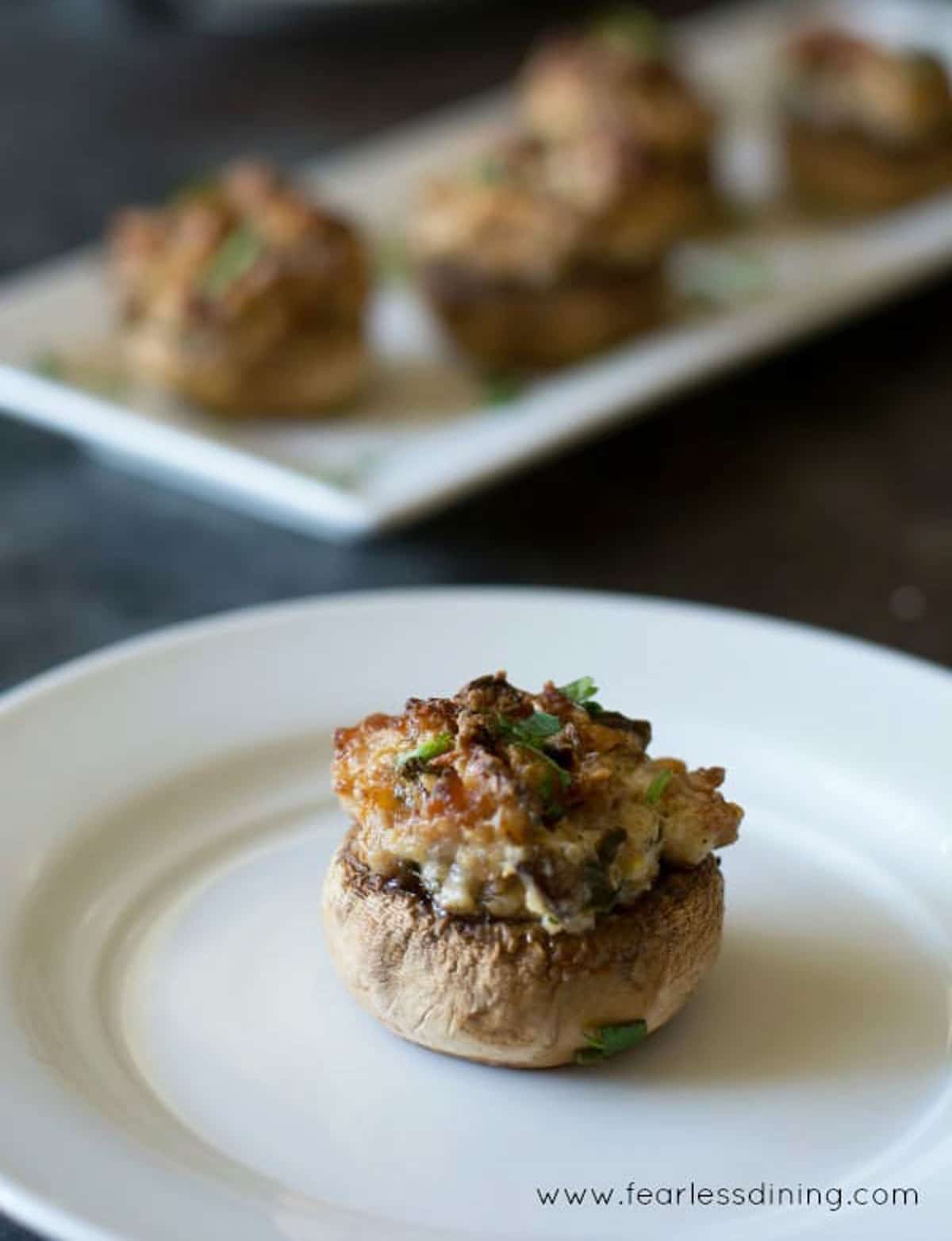 A stuffed mushroom on a plate.