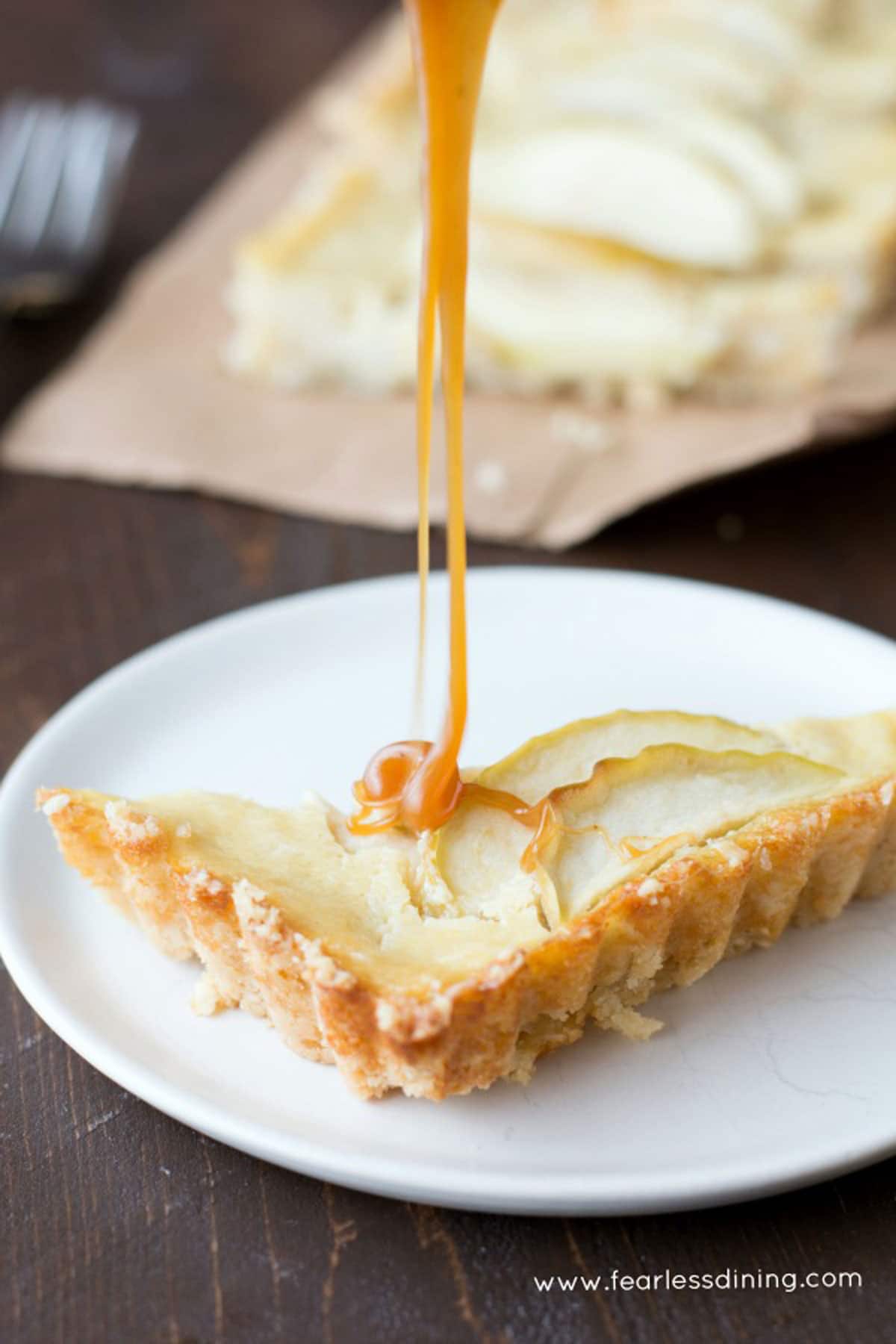 a slice of caramel apple tart on a plate