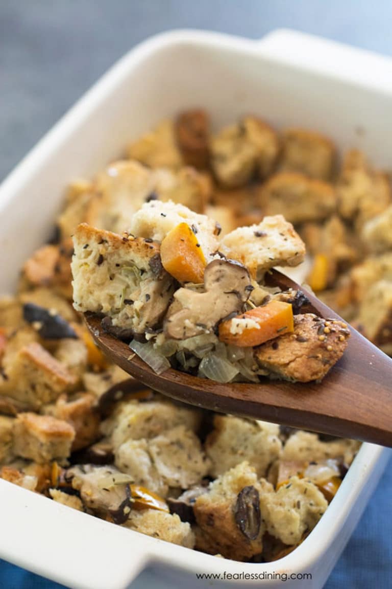 A closeup of a wooden spoon full of the dressing.