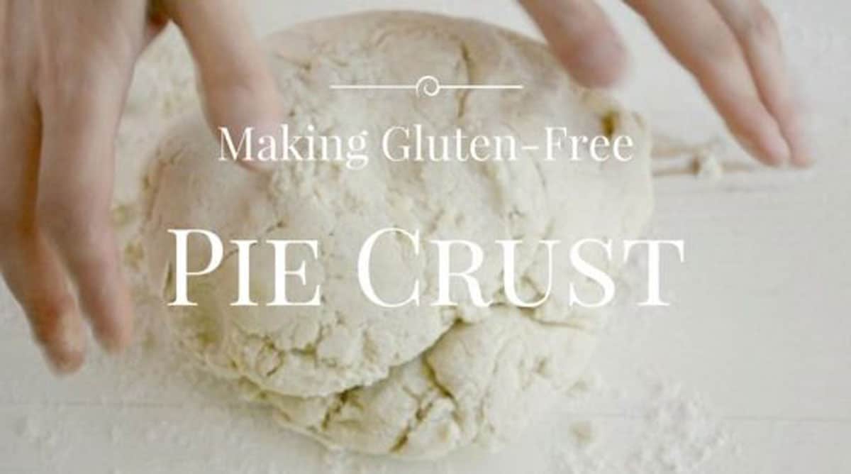 Hands shaping pie crust dough.
