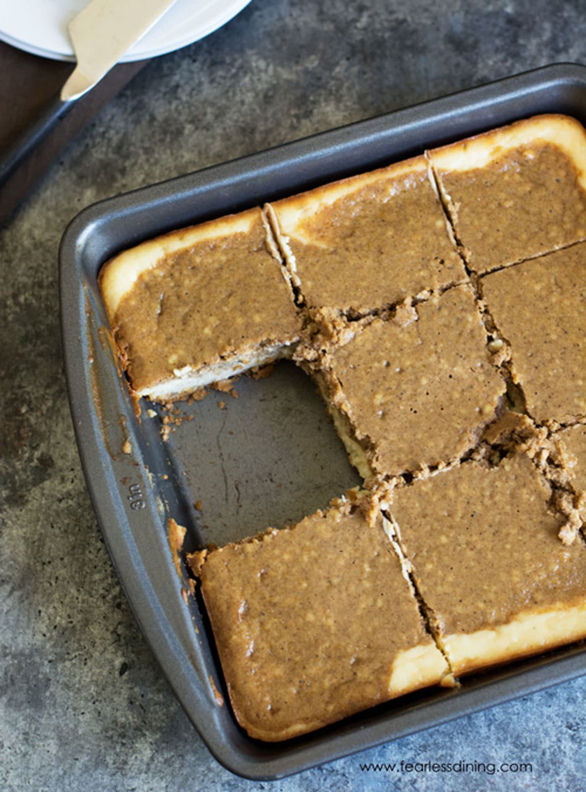 The top view of a pan of gingerbread cheesecake bars.