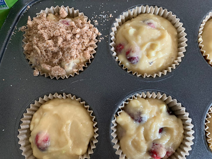 Adding the streusel topping on the muffin batter.