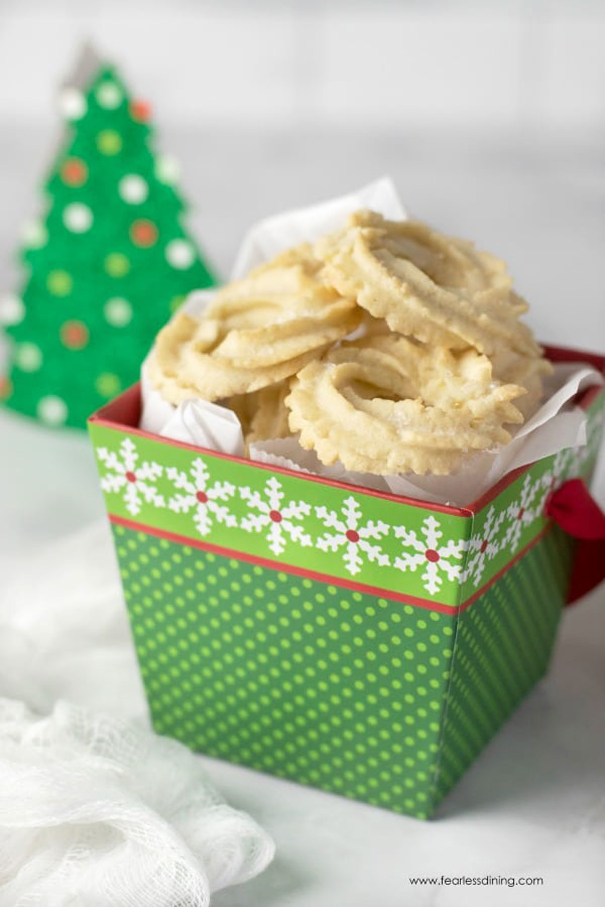 A green gift box filled with butter cookies.