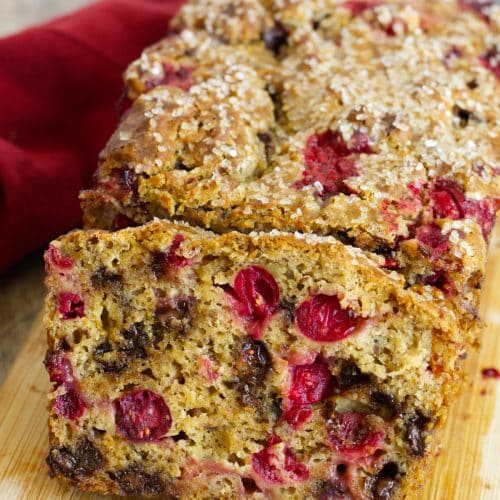 A sliced loaf of gluten free cranberry chocolate chip bread.