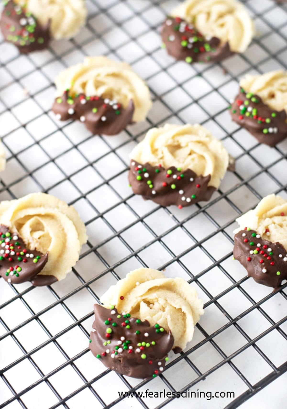 A rack of chocolate dipped butter cookies on a rack.