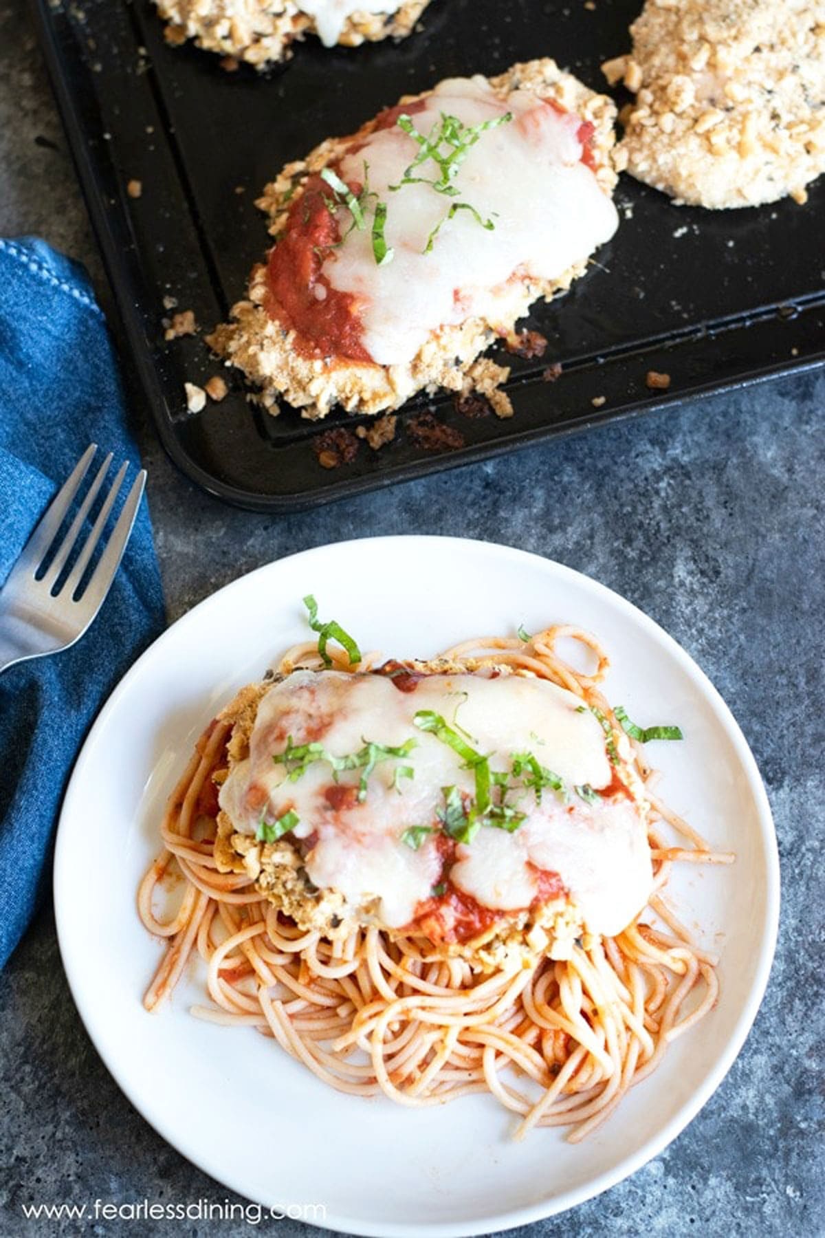 the top view of chicken parmesan over spaghetti