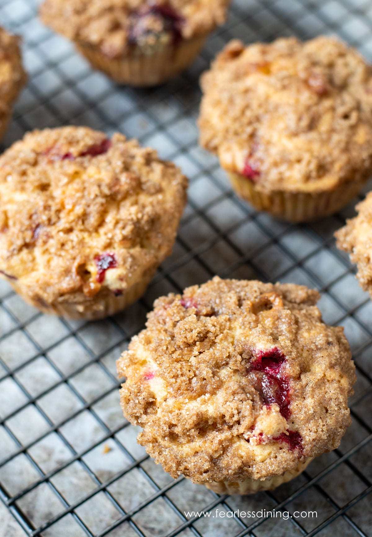 A photo of the gluten free cranberry muffins on a cooling rack.