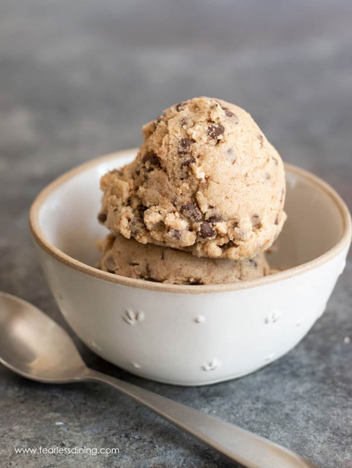 A bowl filled with scoops of edible cookie dough.
