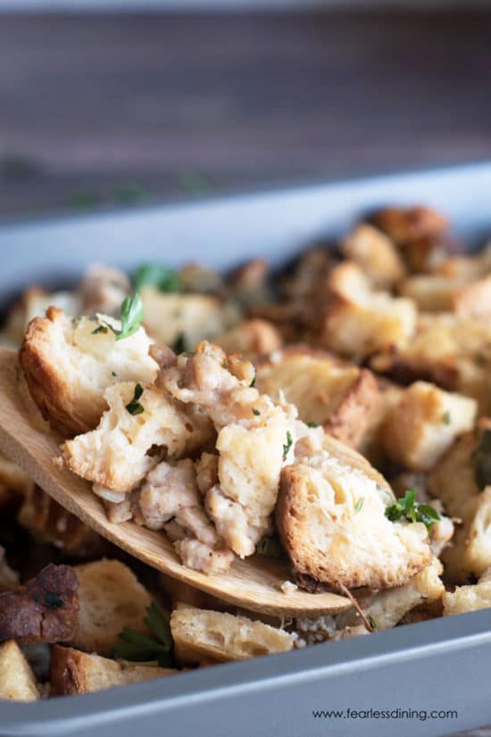 A serving spoon full of gluten free stuffing.