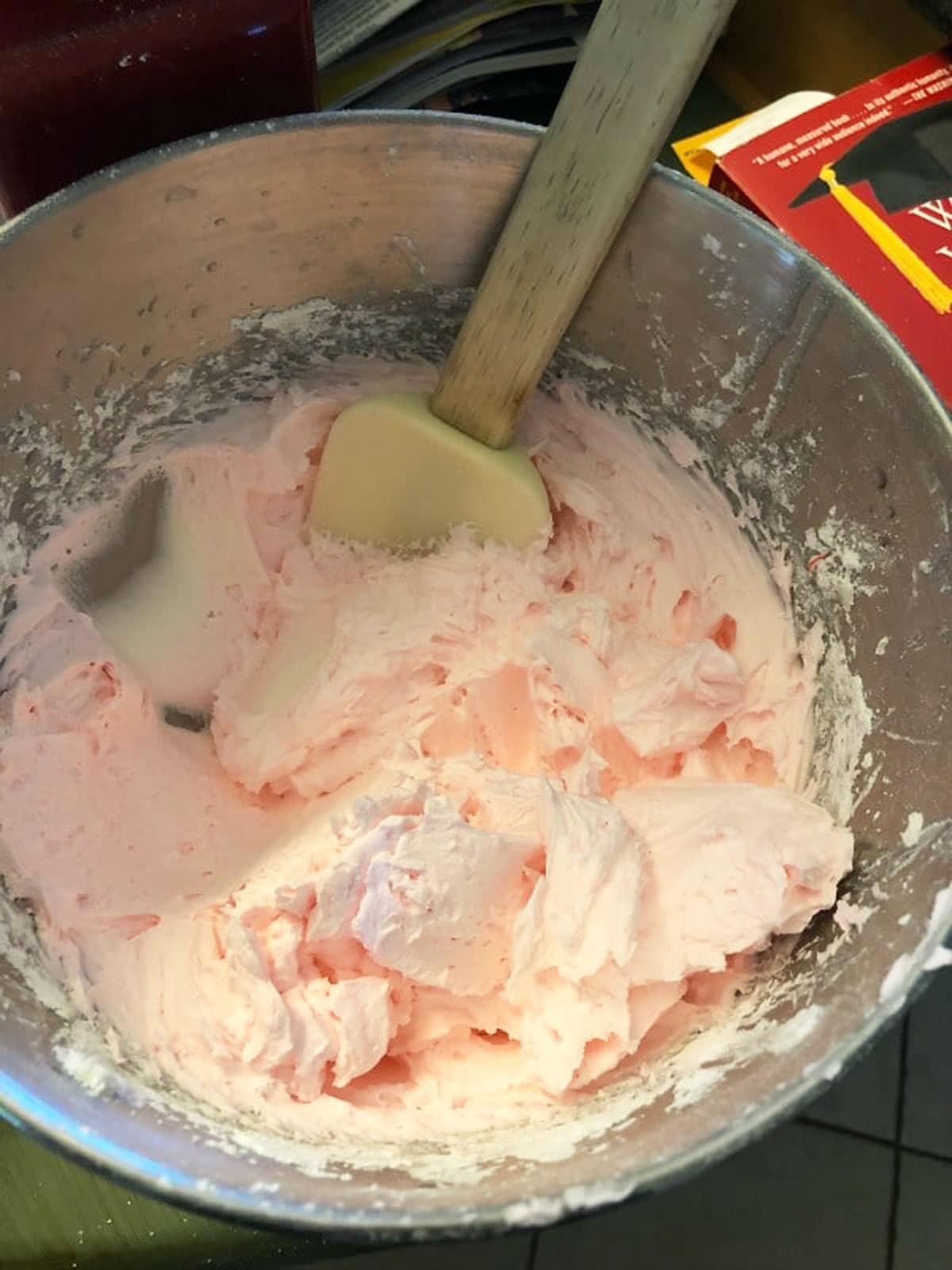A bowl of light pink frosting.