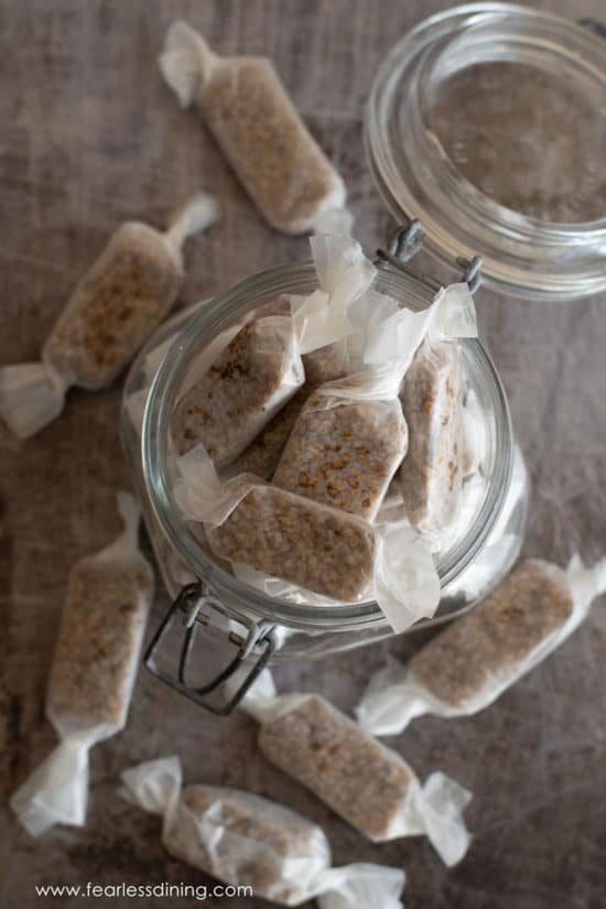 A top view of a mason jar filled with wrapped candies.