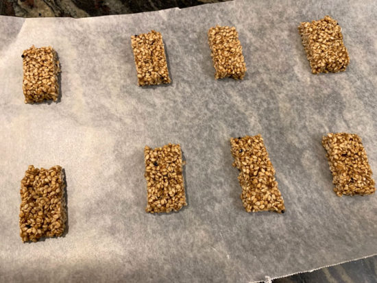 Cut pieces of honey sesame candy on wax paper.