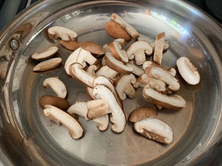 Shiitake cooking in a pan.