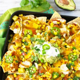 a giant sheet pan full of chicken nachos