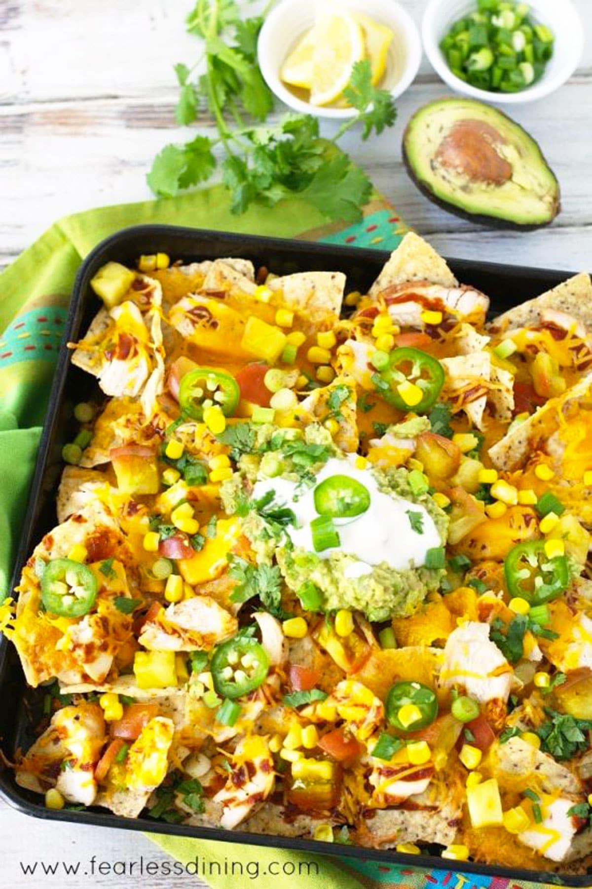 A giant sheet pan full of chicken nachos.